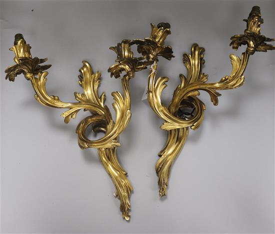 A pair of bronze two branch wall lights height 42cm